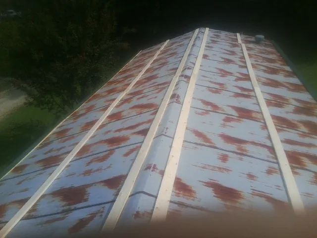 Rusted metal roof panels with new wood purlins before replacement — Storm Damage Roof Repair in Cynthiana by Roofing Brothers