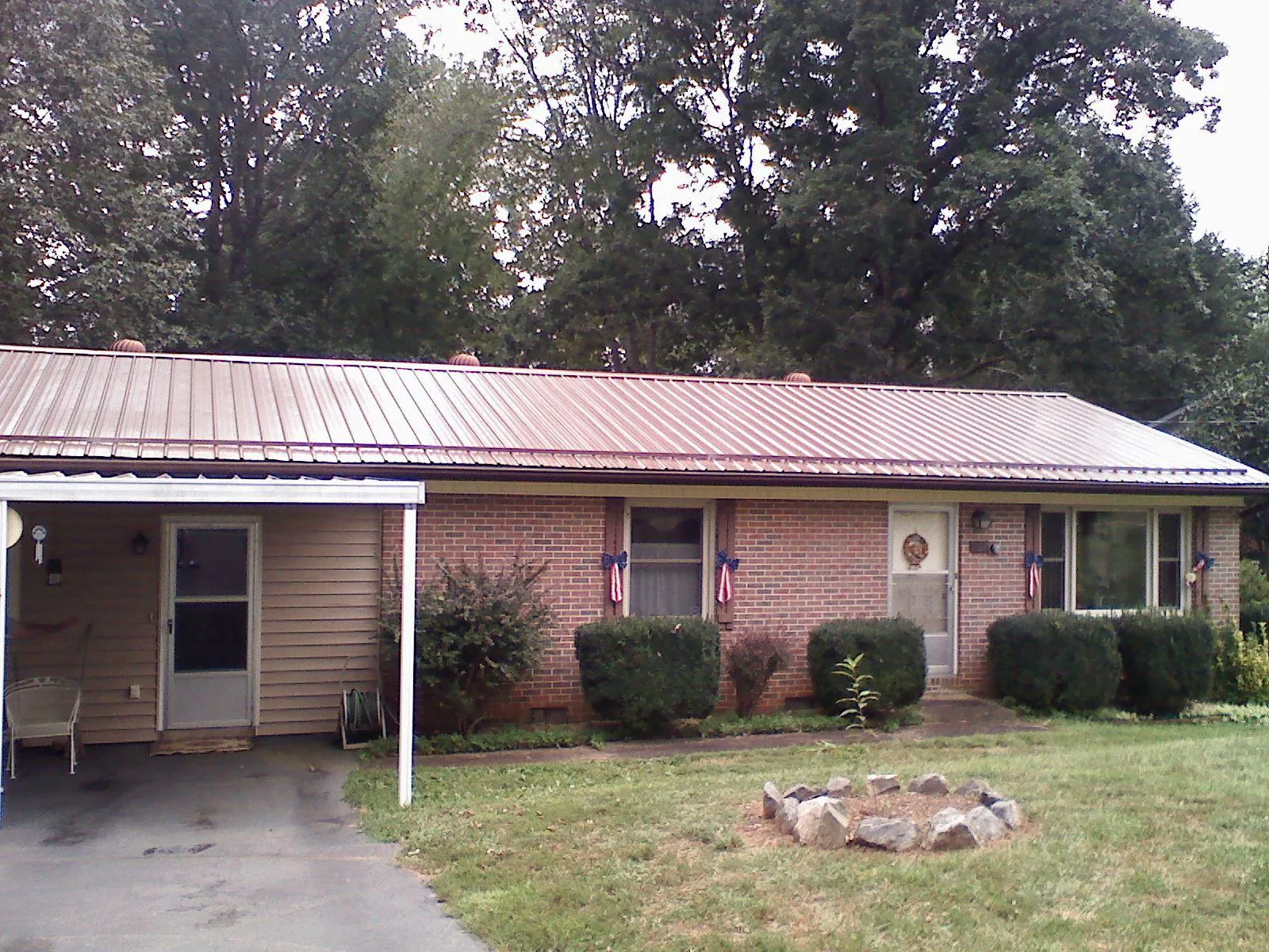 Bronze metal roof and carport on a brick ranch home — Roof Repair work by our crew in Cynthiana